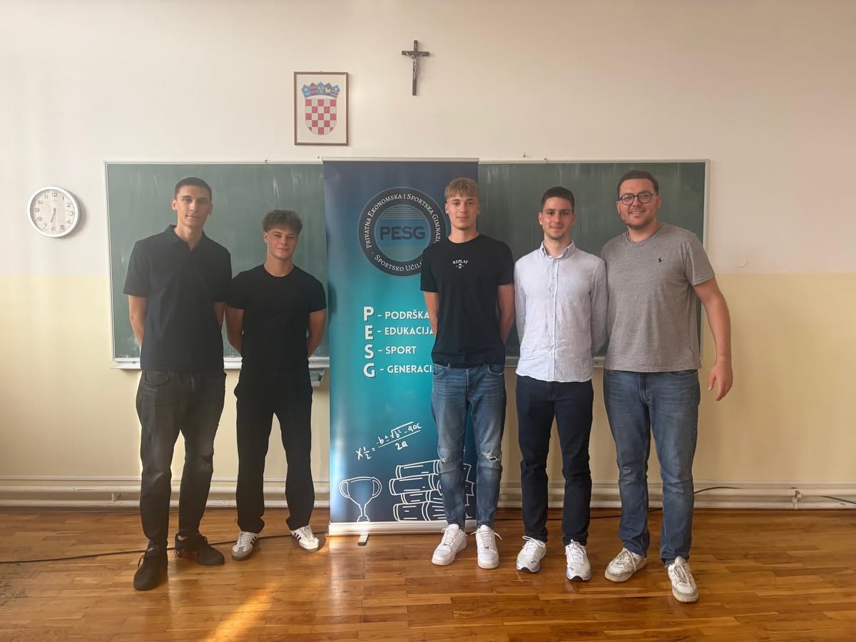 Five young men stand side by side in a classroom, posing in front of a PESG banner with a Croatian crest on the wall behind them, a crucifix above the board visible in the background.