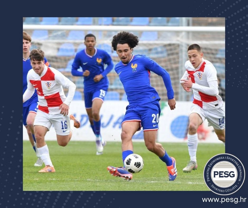 Soccer players in blue and white kits chase a ball on a grassy pitch during a match; PESG logo appears in the bottom-right corner.