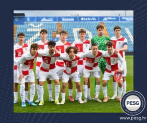 Croatian national football team posing for a group photo on the field in white and red striped kits; goalkeeper in green stands at back.