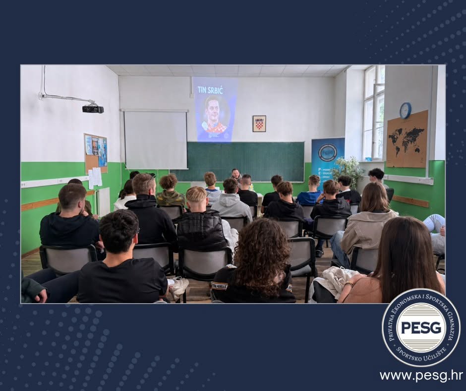 Lecture hall with students facing a speaker at the front as a projector shows a portrait on the screen nearby, PESG event setting.